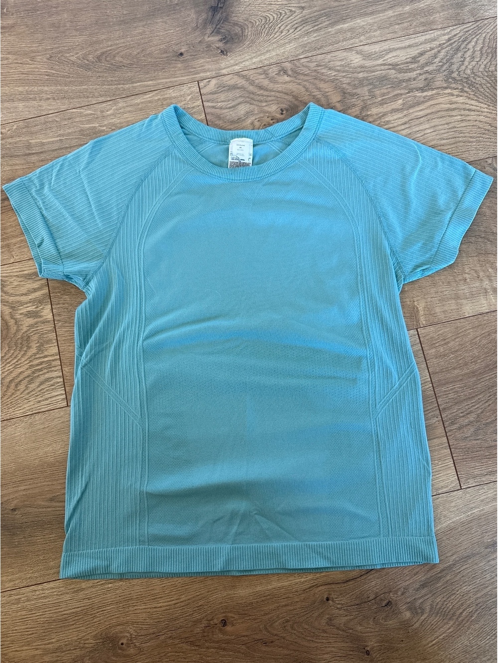 Light teal women’s workout top